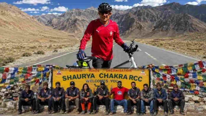 Cyclist Vinod Yadav posing with his bicycle during the Manali to Leh Himalayan expedition