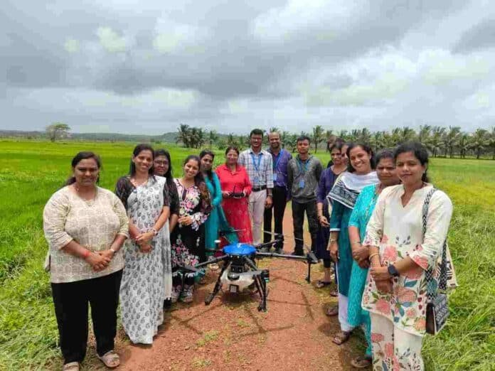 The first cohort of 12 women trained under the Drone Didi initiative demonstrating drone flights in Goa.