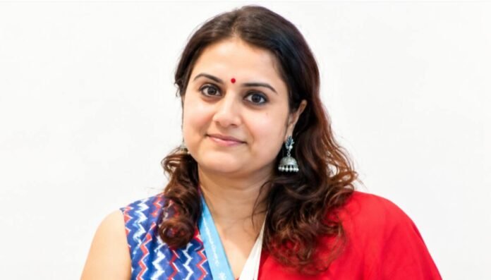 Author Priya Tikhe holding her short story collection Six Windows Into the Soul during an interview